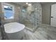 Bathroom featuring a walk-in shower, a freestanding soaking tub, and floor-to-ceiling tile at 3189 A Jackson, Hapeville, GA 30354