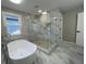 Modern bathroom features a soaking tub, glass shower, and marble-look tile at 3189 A Jackson, Hapeville, GA 30354