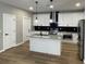 Modern kitchen featuring white cabinets, granite countertops, a kitchen island, and stainless steel appliances at 3189 A Jackson, Hapeville, GA 30354