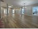 Expansive living room boasts modern chandelier, beautiful wood floors, and lots of natural light at 3189 A Jackson, Hapeville, GA 30354