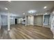 Spacious living room with modern floors leading into kitchen and staircase at 3189 A Jackson, Hapeville, GA 30354
