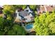 Aerial view of a home with a private pool, a deck, lush landscaping, and mature trees at 4820 Coppedge Trl, Duluth, GA 30096