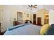 Comfortable bedroom with a blue comforter, hardwood floors, and a view to an ensuite bathroom at 4820 Coppedge Trl, Duluth, GA 30096