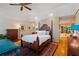 Comfortable bedroom with a cozy rug, a four poster bed, a dresser, and good light at 4820 Coppedge Trl, Duluth, GA 30096