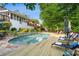Inviting backyard pool with a stone surround and a spacious wooden deck at 4820 Coppedge Trl, Duluth, GA 30096