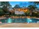 Stunning backyard pool with stone accents, lush landscaping, and deck perfect for outdoor entertaining at 4820 Coppedge Trl, Duluth, GA 30096