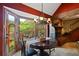 Charming dining room boasts a round table, brick fireplace, and access to the outdoor deck at 4820 Coppedge Trl, Peachtree Corners, GA 30096