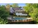A pristine pool with a surrounding deck enhances the backyard of this stylish white home at 4820 Coppedge Trl, Peachtree Corners, GA 30096