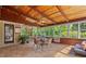 Bright sun room with tile floors, wood paneling, and a comfortable seating area at 4820 Coppedge Trl, Peachtree Corners, GA 30096