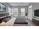 Relaxing bedroom with plush bedding, large windows, and a patio door at 1203 Stratford Commons Commons, Decatur, GA 30030