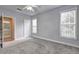 Carpeted bedroom features an open door to the primary bath and a large window at 1203 Stratford Commons Commons, Decatur, GA 30030