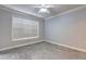 An empty bedroom featuring gray walls, white trim, carpet flooring and a window at 1203 Stratford Commons Commons, Decatur, GA 30030
