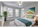 This staged bedroom features large windows, carpeted floors and neutral walls at 1203 Stratford Commons Commons, Decatur, GA 30030