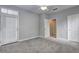 Spacious carpeted bedroom featuring a patio door, ceiling fan, and interior door at 1203 Stratford Commons Commons, Decatur, GA 30030