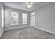 This bedroom is staged with grey walls, carpeted floor and a view to the outside at 1203 Stratford Commons Commons, Decatur, GA 30030