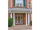 Brick entrance with columns and covered awning in front of glass paned entry door at 1203 Stratford Commons Commons, Decatur, GA 30030
