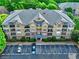 Aerial view of condo building featuring balconies, green shutters and reserved parking at 1203 Stratford Commons Commons, Decatur, GA 30030