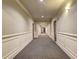 Hallway with carpet and paneled walls leading to doorways and an arched opening at 1203 Stratford Commons Commons, Decatur, GA 30030