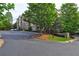 View of condo building showing corner with parking area, sidewalks and grass at 1203 Stratford Commons Commons, Decatur, GA 30030