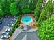 Aerial view of neighborhood pool surrounded by trees, lounge chairs, parking and a pool house at 1203 Stratford Commons Commons, Decatur, GA 30030
