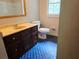 Bathroom with vanity, toilet, window and unique blue patterned tile floor at 2553 Country Club Dr, Conyers, GA 30013