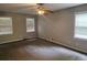 Spacious bedroom with overhead ceiling fan, neutral walls, and two windows offering natural light at 2553 Country Club Dr, Conyers, GA 30013