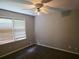 Bedroom with window and ceiling fan with new carpeting at 2553 Country Club Dr, Conyers, GA 30013