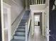 Inviting foyer with staircase, light gray walls, white trim, and durable floors lead into the home's interior at 2553 Country Club Dr, Conyers, GA 30013