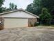 Garage featuring driveway and partial brick facade at 2553 Country Club Dr, Conyers, GA 30013