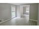 Bright living room features new gray floors, fresh neutral paint, crown molding, and natural light at 2553 Country Club Dr, Conyers, GA 30013