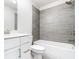 Updated bathroom boasts modern gray tiling in shower and white vanity at 2560 Clairebrooke Bnd, Atlanta, GA 30341