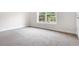 Bright, carpeted bedroom featuring a window allowing natural light to stream into the space, with neutral walls at 2560 Clairebrooke Bnd, Atlanta, GA 30341