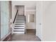 Bright entryway with a modern staircase featuring black and white accents and sleek, light-colored hardwood flooring at 2560 Clairebrooke Bnd, Atlanta, GA 30341