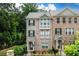 Beautiful brick townhome featuring black shutters, a gray roof and a small front yard with a black metal fence at 2560 Clairebrooke Bnd, Atlanta, GA 30341