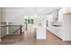 Open-concept kitchen with an island, stainless appliances, hardwood floors, and a seamless flow to the living area at 2560 Clairebrooke Bnd, Atlanta, GA 30341