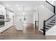 Modern kitchen with a large island, stainless steel appliances, hardwood floors, and a seamless flow to a staircase at 2560 Clairebrooke Bnd, Atlanta, GA 30341