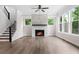 Living room with fireplace, hardwood floors, staircase, and large windows at 2560 Clairebrooke Bnd, Atlanta, GA 30341