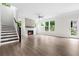 Bright living room with fireplace, hardwood floors, staircase, and french doors at 2560 Clairebrooke Bnd, Atlanta, GA 30341