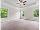 Spacious main bedroom with tray ceiling, fan, carpet and large windows at 2560 Clairebrooke Bnd, Atlanta, GA 30341