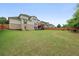 Spacious backyard features a well-maintained lawn, wooden fence, and deck perfect for entertaining at 2921 Terra View Sw Dr, Lilburn, GA 30047