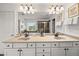 Bright bathroom with double vanity, modern fixtures, and a large mirror reflecting natural light at 2921 Terra View Sw Dr, Lilburn, GA 30047