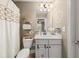 Charming bathroom with a rope-themed shower curtain, vanity, and decorative accents at 2921 Terra View Sw Dr, Lilburn, GA 30047