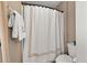 Cozy bathroom features a shower with a decorative curtain and a clean, classic toilet at 2921 Terra View Sw Dr, Lilburn, GA 30047