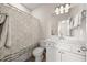 Clean bathroom with white cabinets, a patterned shower curtain, and a well-lit mirror at 2921 Terra View Sw Dr, Lilburn, GA 30047