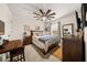 Comfortable bedroom with a decorative ceiling fan, neutral tones, and stylish furnishings at 2921 Terra View Sw Dr, Lilburn, GA 30047