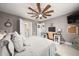 Bright bedroom with a ceiling fan, desk, ensuite bath, and neutral decor at 2921 Terra View Sw Dr, Lilburn, GA 30047