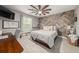 Stylish bedroom featuring a decorative wood wall, ceiling fan, and a comfortable bed at 2921 Terra View Sw Dr, Lilburn, GA 30047