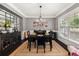 Formal dining room with dark wood table and chairs, and decorative mirror at 2921 Terra View Sw Dr, Lilburn, GA 30047
