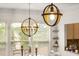 Elegant dining room featuring modern globe chandeliers and large windows with natural light at 2921 Terra View Sw Dr, Lilburn, GA 30047