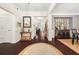 Elegant entryway with hardwood floors, decorative rug, and wainscoting at 2921 Terra View Sw Dr, Lilburn, GA 30047